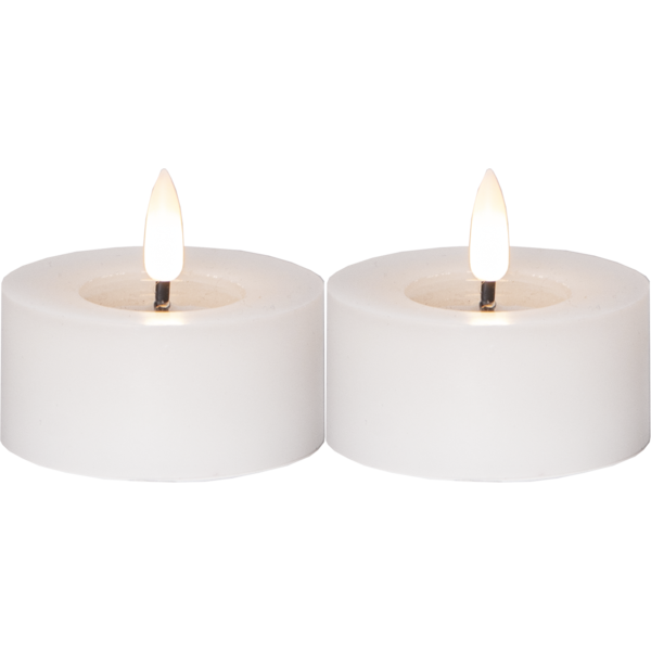 Um par de velas grossas brancas LED baixas